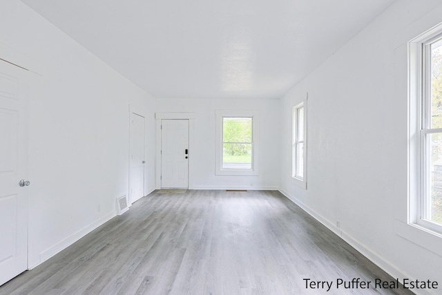 unfurnished room featuring wood finished floors and baseboards