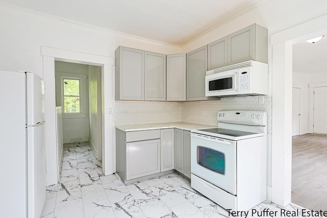 kitchen with white appliances, gray cabinetry, decorative backsplash, and ornamental molding