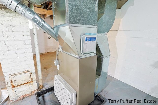 utility room featuring heating unit
