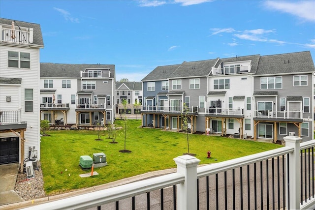 view of home's community with a residential view and a lawn
