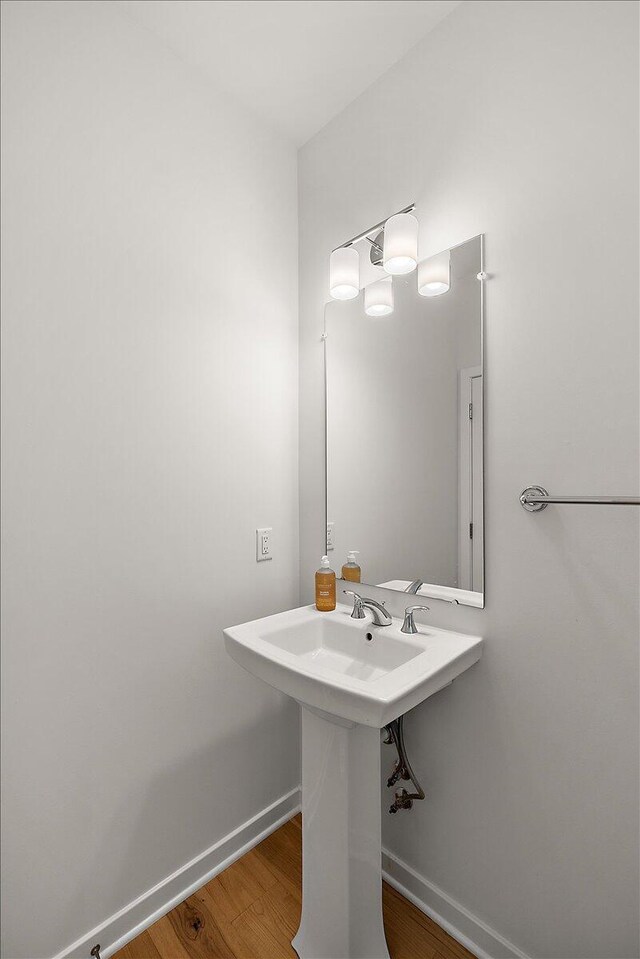 bathroom featuring baseboards and wood finished floors