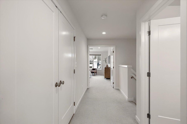 hall featuring light colored carpet, recessed lighting, and baseboards