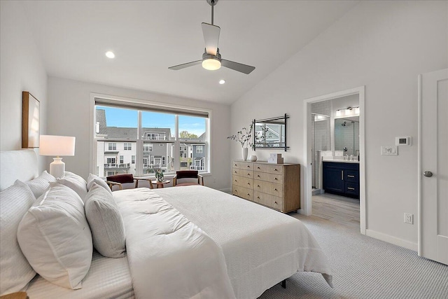 bedroom featuring lofted ceiling, light colored carpet, connected bathroom, baseboards, and recessed lighting
