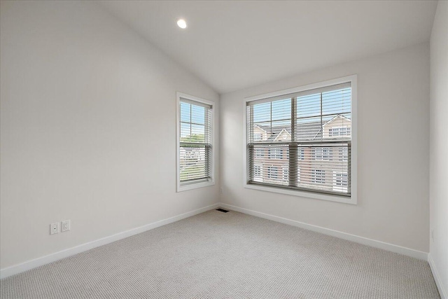 spare room with carpet flooring, baseboards, lofted ceiling, and recessed lighting
