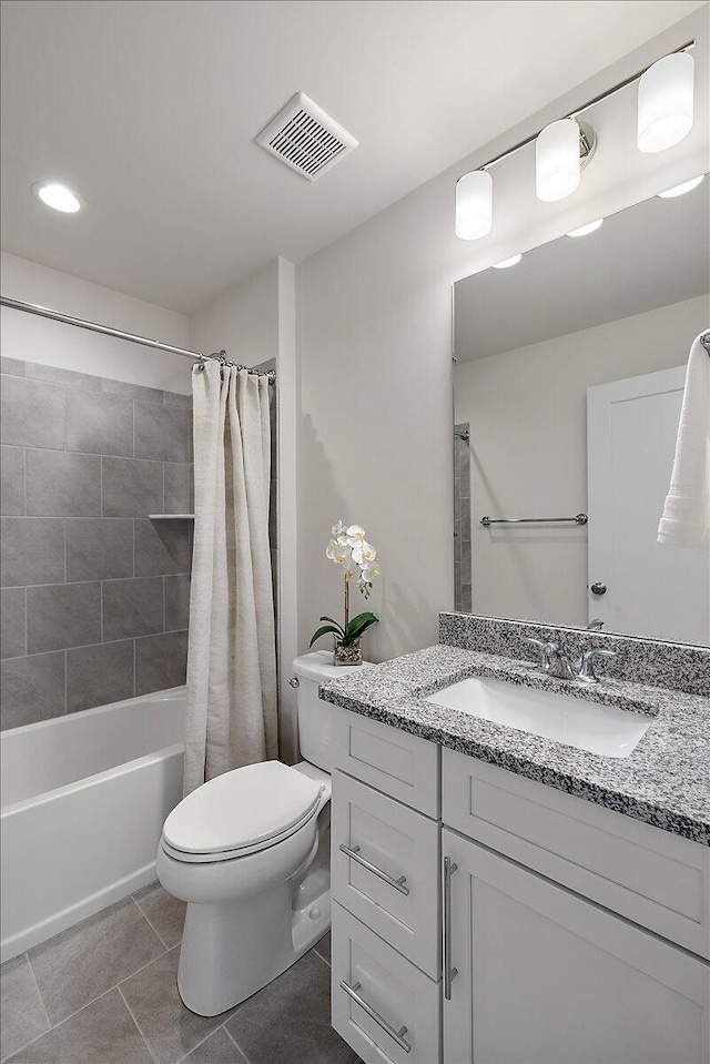 bathroom featuring toilet, tile patterned floors, vanity, shower / bath combo with shower curtain, and recessed lighting