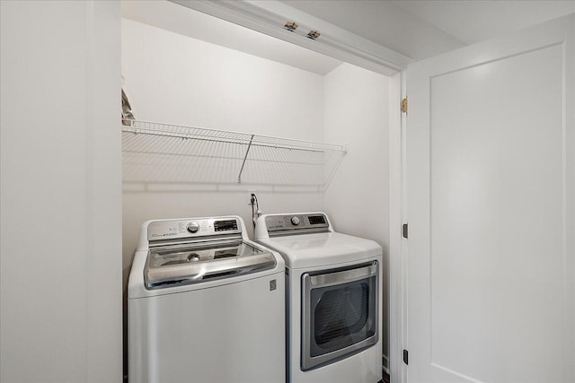 clothes washing area with washing machine and clothes dryer