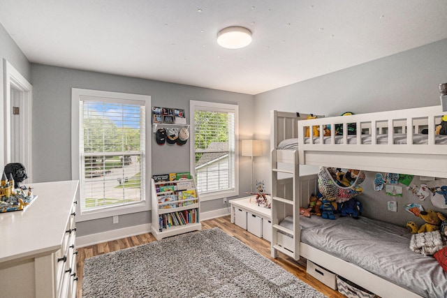 bedroom featuring light wood-style floors and baseboards