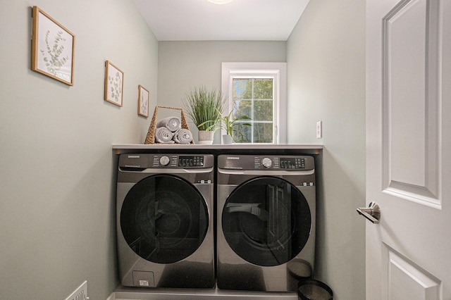 washroom featuring washing machine and dryer