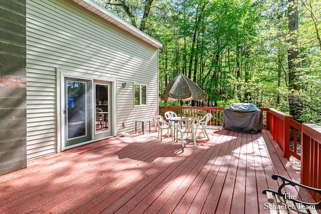 10436 Morgan Mills Ave NE, Greenville, MI 48838 - wooden deck with outdoor dining space and grilling area