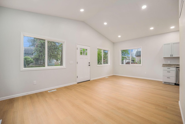 unfurnished living room featuring recessed lighting, light wood-style flooring, baseboards, and vaulted ceiling