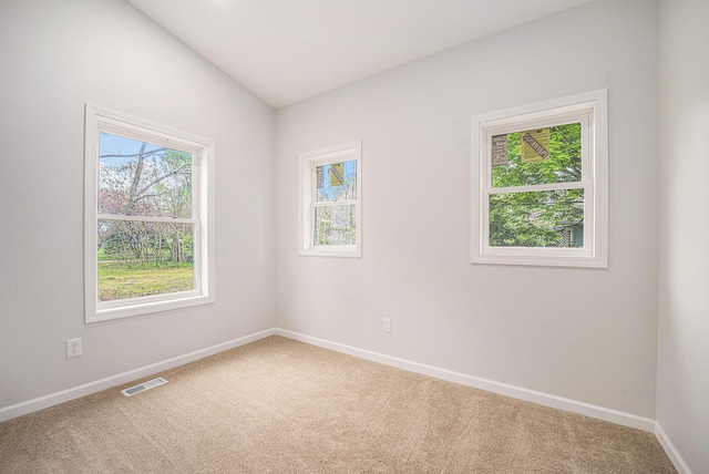 carpeted spare room featuring baseboards