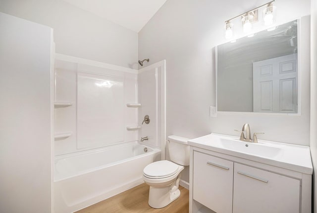 bathroom featuring toilet, vanity, bathing tub / shower combination, and wood finished floors