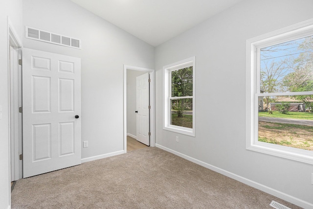 408 W Exchange St, Gobles, MI 49055 - unfurnished bedroom featuring carpet floors, lofted ceiling, and baseboards