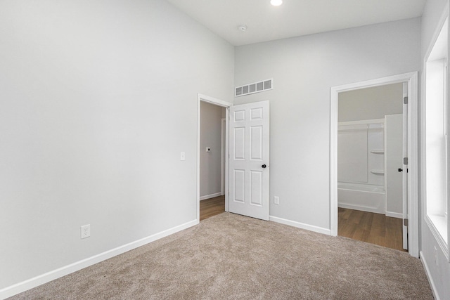 408 W Exchange St, Gobles, MI 49055 - unfurnished bedroom with carpet floors, baseboards, and high vaulted ceiling