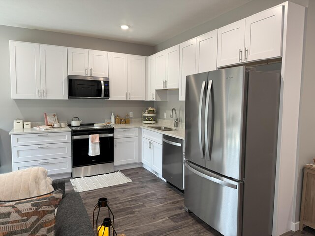 887 Rex St, Fremont, MI 49412 - kitchen with appliances with stainless steel finishes, a sink, white cabinets, and recessed lighting