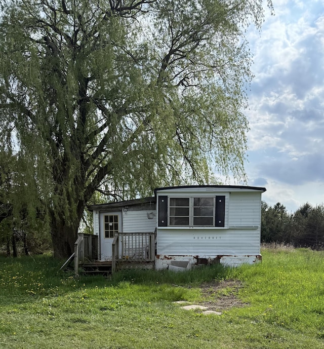 back of property with a wooden deck