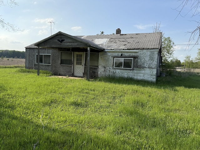 view of front facade with a chimney