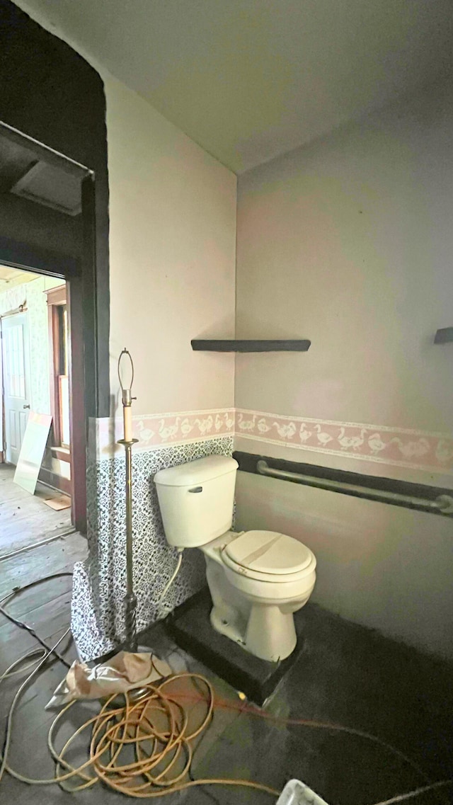 8059 N Wheeler Rd, Wheeler, MI 48662 - bathroom featuring toilet and a wainscoted wall