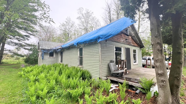 8059 N Wheeler Rd, Wheeler, MI 48662 - view of side of home with a wooden deck and metal roof