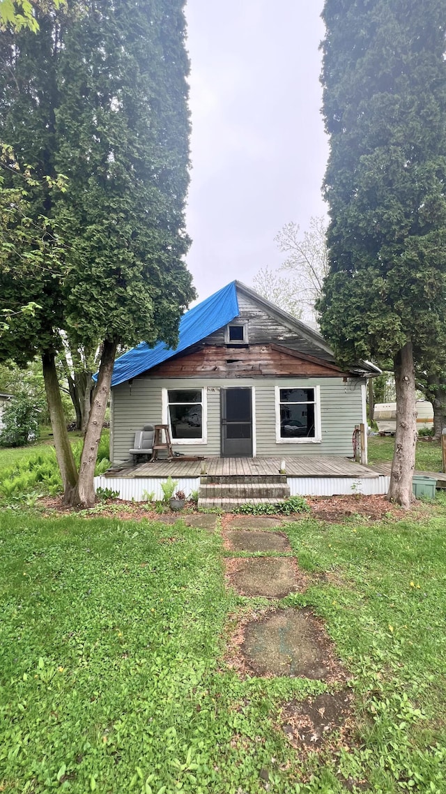 8059 N Wheeler Rd, Wheeler, MI 48662 - rear view of house with a deck and a lawn