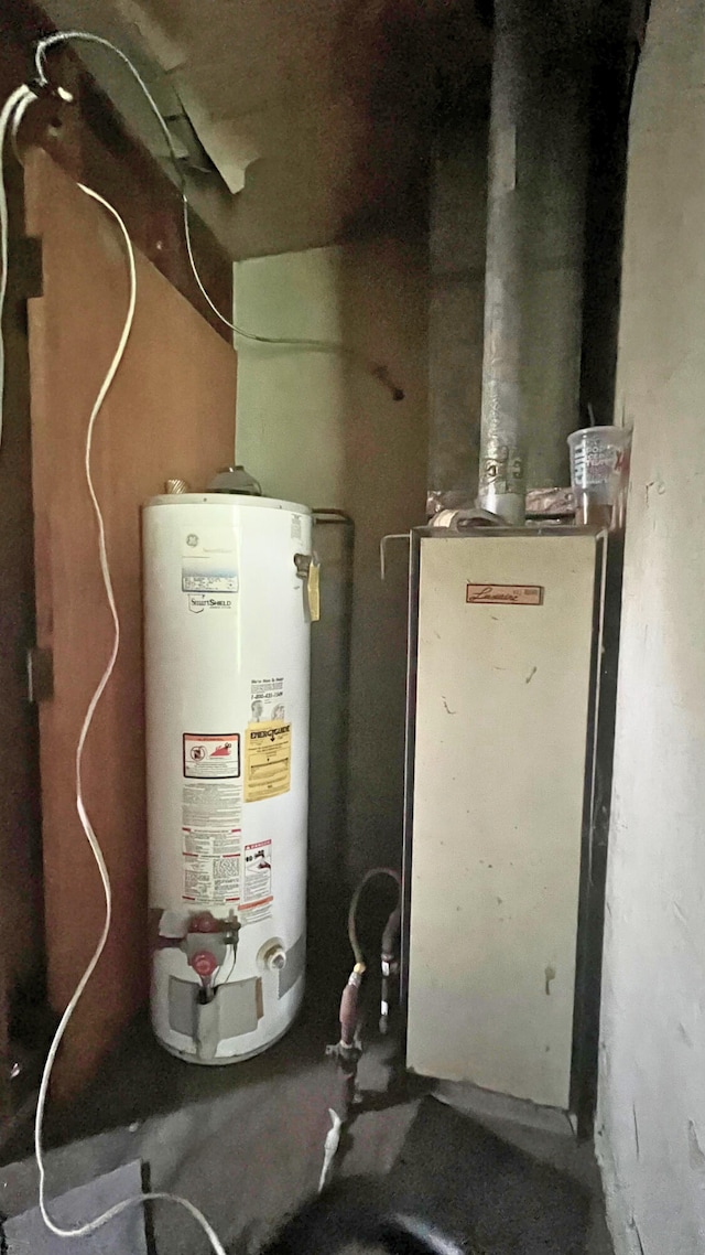 8059 N Wheeler Rd, Wheeler, MI 48662 - utility room featuring water heater
