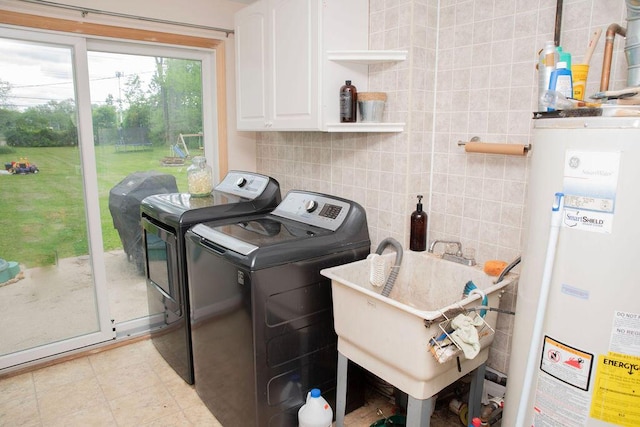 19610 Brentwood St, Livonia, MI 48152 - clothes washing area with water heater, washer and dryer, and cabinet space