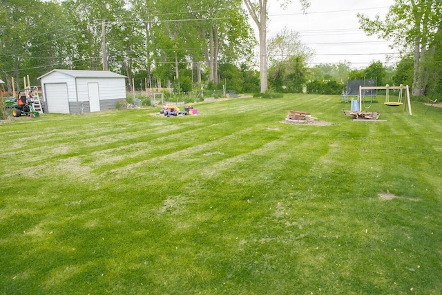19610 Brentwood St, Livonia, MI 48152 - view of grassy yard with an outdoor fire pit, an outbuilding, and view of scattered trees