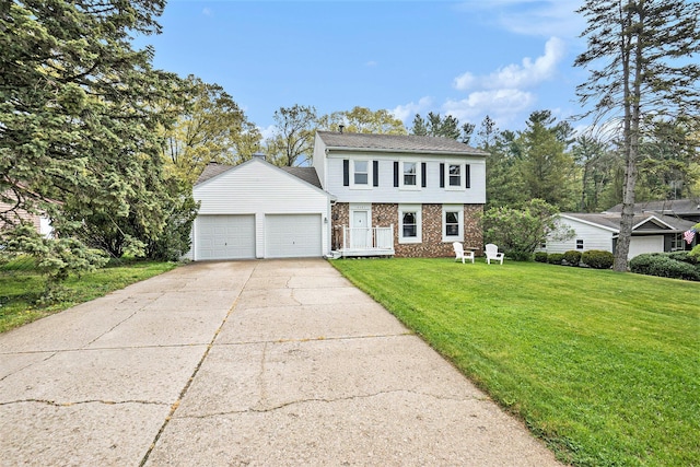 colonial home featuring brick siding, an attached garage, a front yard, and concrete driveway