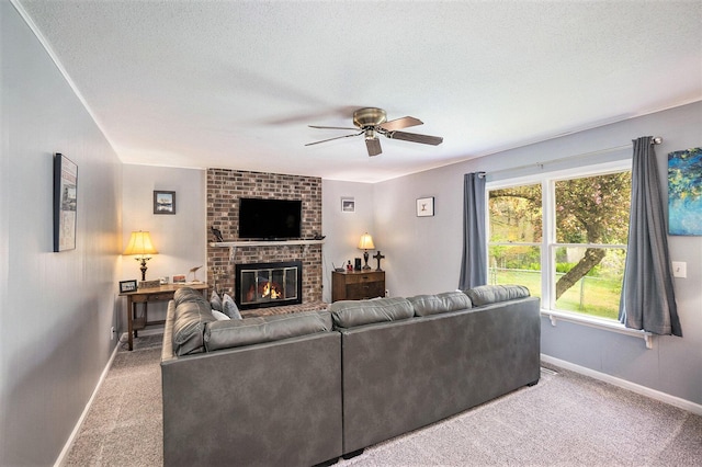 carpeted living area featuring ceiling fan, baseboards, a fireplace, and a textured ceiling