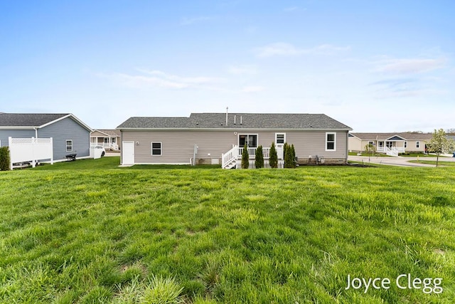4755 Boulder Dr, Holland, MI 49423 - rear view of house featuring a yard