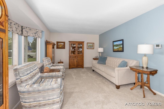 living area featuring carpet flooring and baseboards