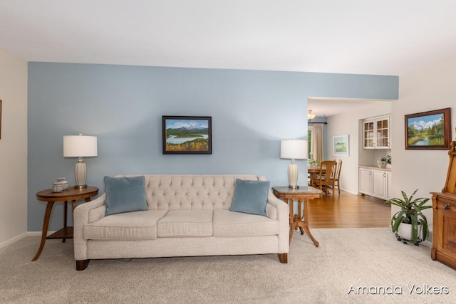 living room with carpet and baseboards