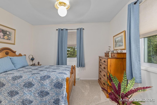 bedroom with light carpet and baseboards