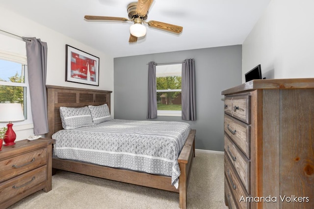 bedroom with light carpet and ceiling fan