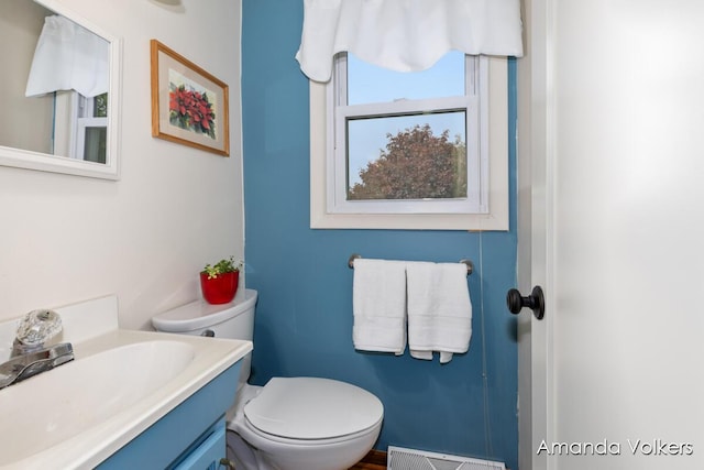 bathroom with toilet and vanity