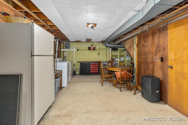 basement featuring freestanding refrigerator, carpet, and washer and clothes dryer