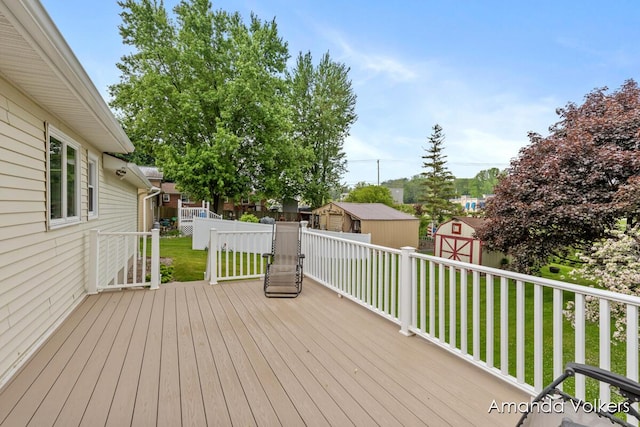 wooden deck with a storage unit and an outbuilding