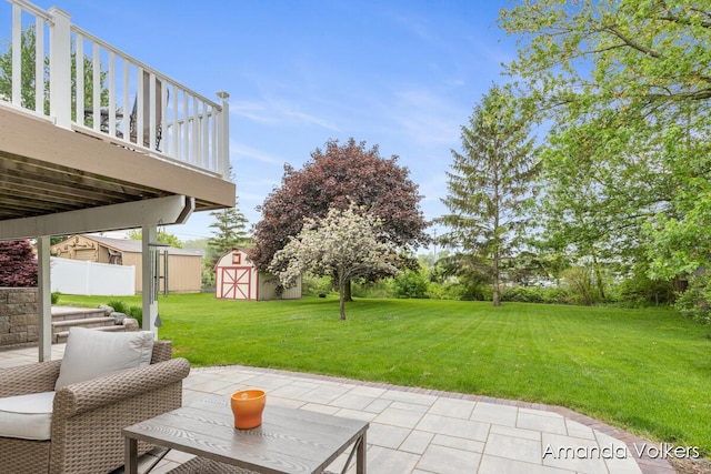 view of patio / terrace with a shed and an outbuilding