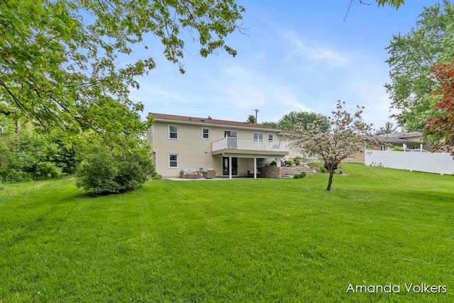 back of property with a patio area and a wooden deck