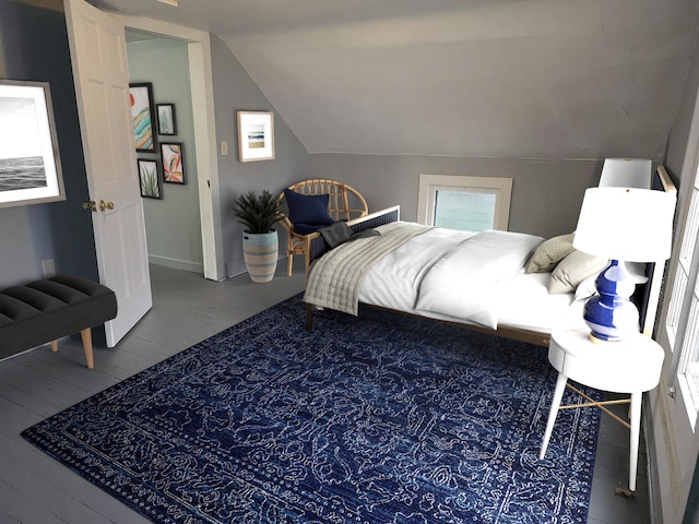 bedroom featuring lofted ceiling and wood finished floors