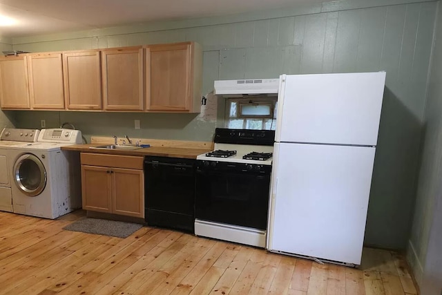 kitchen with freestanding refrigerator, gas range oven, dishwasher, separate washer and dryer, and a sink