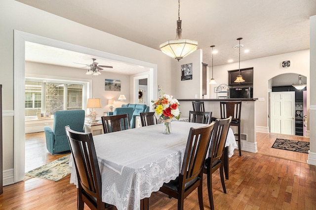 705.5 E Ludington Ave, Ludington, MI 49431 - dining area with hardwood / wood-style flooring, a ceiling fan, arched walkways, recessed lighting, and baseboards