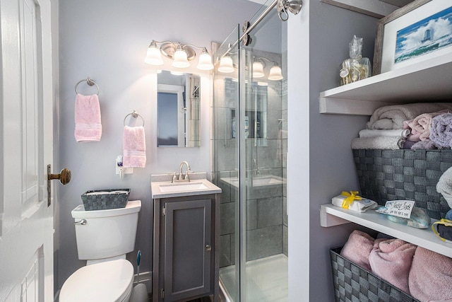705.5 E Ludington Ave, Ludington, MI 49431 - full bathroom with a stall shower, vanity, and toilet