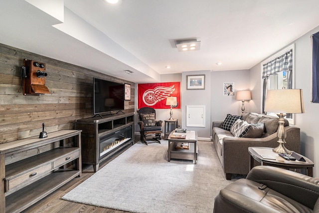 705.5 E Ludington Ave, Ludington, MI 49431 - living room featuring wood finished floors, recessed lighting, and wood walls