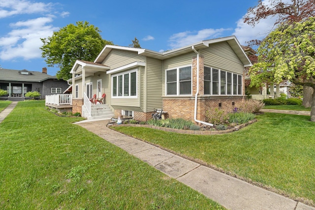 705.5 E Ludington Ave, Ludington, MI 49431 - view of front of home with a front yard and brick siding