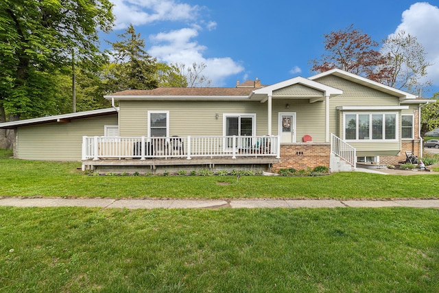 705.5 E Ludington Ave, Ludington, MI 49431 - view of front of home featuring a wooden deck, a front lawn, and a chimney