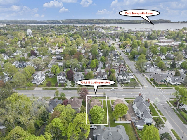 705.5 E Ludington Ave, Ludington, MI 49431 - aerial perspective of suburban area with property boundaries highlighted and a nearby body of water
