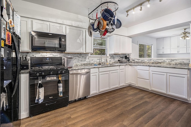 kitchen featuring black appliances, a sink, decorative backsplash, white cabinetry, and dark wood-type flooring