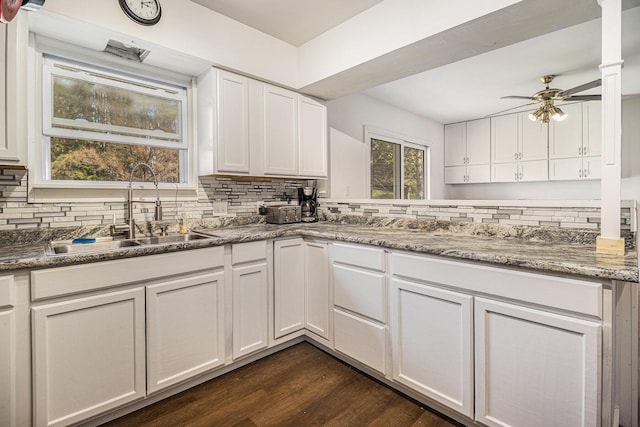kitchen with a sink, tasteful backsplash, white cabinetry, ceiling fan, and dark wood-style flooring