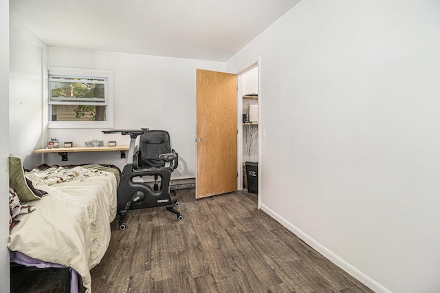 bedroom featuring wood finished floors and baseboards
